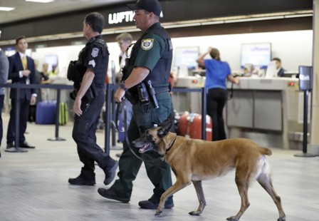 Law enforcement officers patrol the ticketing counters at the Tampa International Airport Friday, Jan. 6, 2017, in Tampa, Fla. Police were on a heightened state of alert after the shooting at an airport today in Fort Lauderdale. (AP Photo/Chris O'Meara)